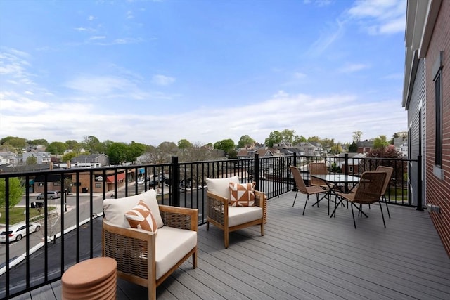 wooden deck featuring outdoor dining area