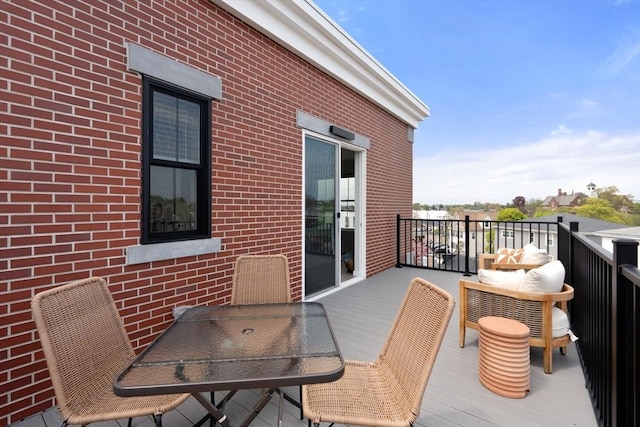 wooden terrace featuring outdoor dining area