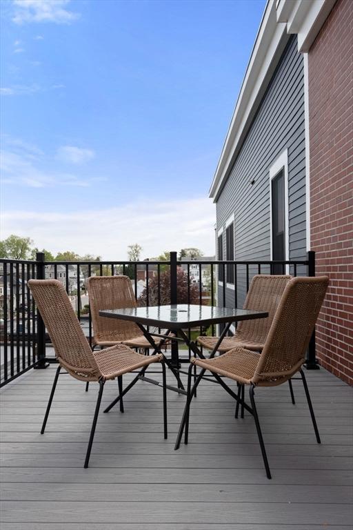 wooden terrace featuring outdoor dining area