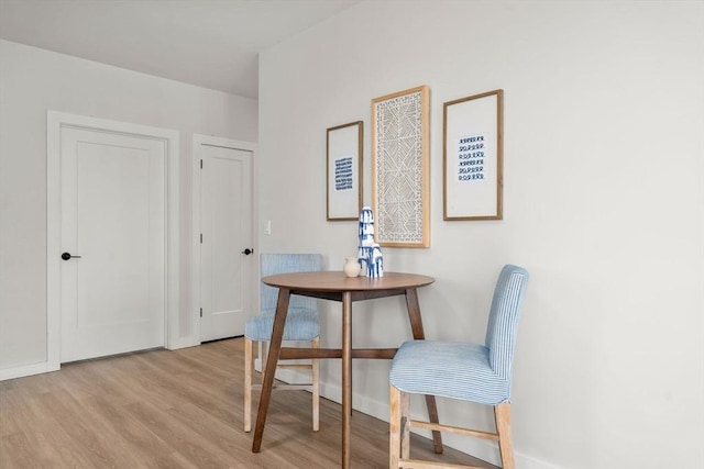 dining area featuring wood finished floors and baseboards