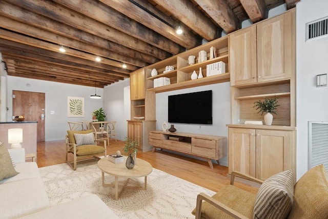 living room featuring light hardwood / wood-style floors and beam ceiling