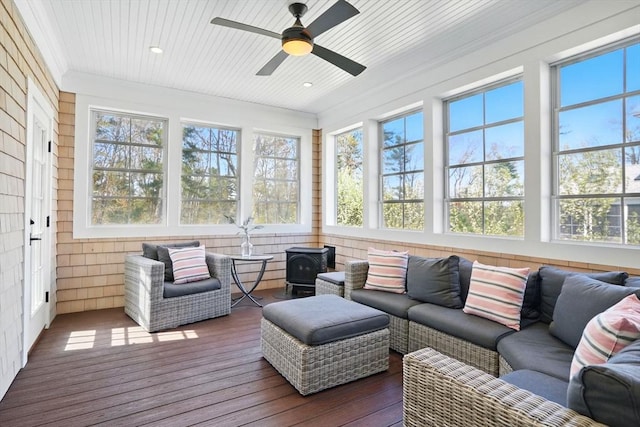 sunroom / solarium featuring an outdoor living space, a ceiling fan, crown molding, and wood-type flooring