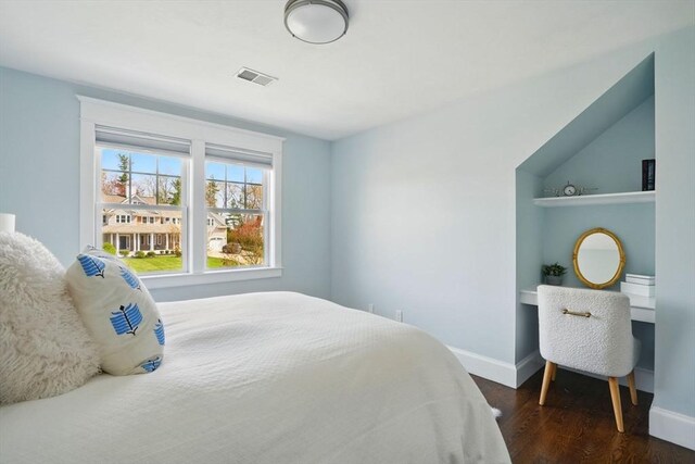 bedroom featuring baseboards, visible vents, and dark wood-type flooring