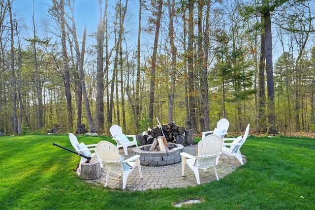 view of yard featuring an outdoor fire pit and a patio area