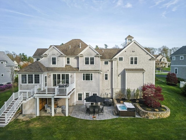 rear view of house featuring a yard, stairway, and a patio area