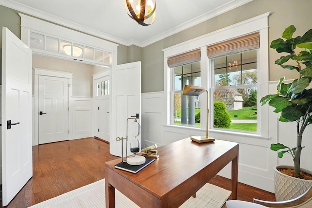 office featuring ornamental molding, a decorative wall, and wood finished floors