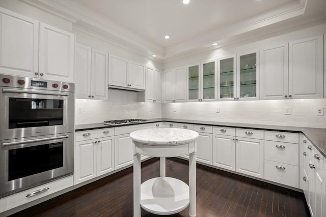 15 Marlborough St Unit 3, Boston, MA 02116 - kitchen with appliances with stainless steel finishes, white cabinets, dark wood-style floors, ornamental molding, and glass insert cabinets