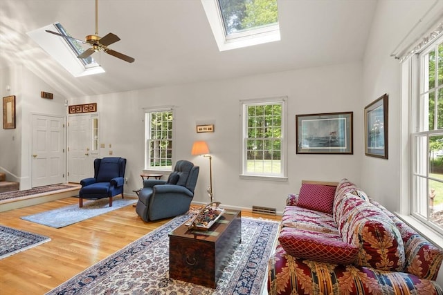 12 Robin Ln, Pepperell, MA 01463 - living room with a skylight, lofted ceiling, healthy amount of natural light, wood finished floors, and ceiling fan