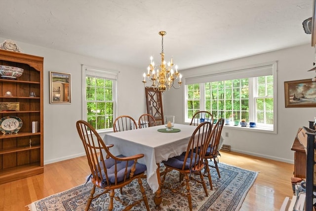 12 Robin Ln, Pepperell, MA 01463 - dining space featuring a chandelier, light wood-type flooring, and baseboards