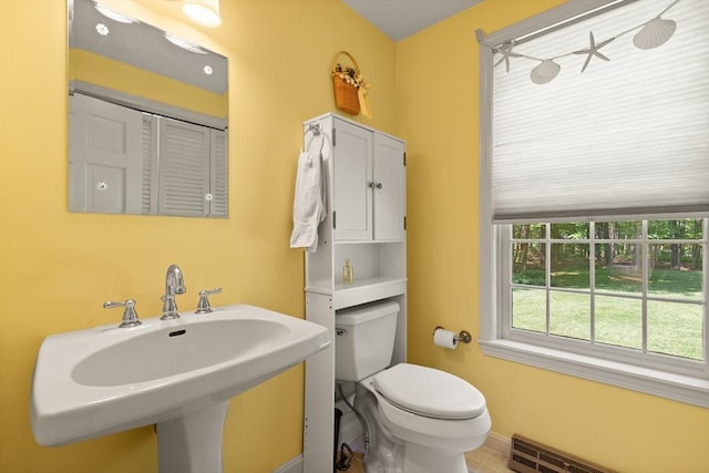 12 Robin Ln, Pepperell, MA 01463 - half bathroom with toilet, a sink, a baseboard radiator, and baseboards