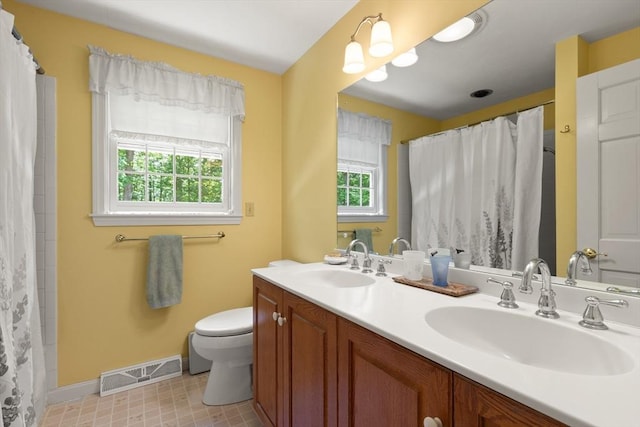 12 Robin Ln, Pepperell, MA 01463 - full bath featuring toilet, double vanity, baseboards, and a shower with curtain