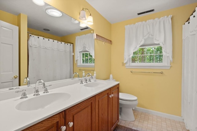 12 Robin Ln, Pepperell, MA 01463 - full bathroom with double vanity, toilet, and baseboards