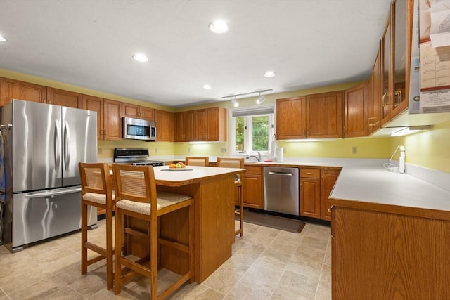 12 Robin Ln, Pepperell, MA 01463 - kitchen featuring appliances with stainless steel finishes, light countertops, brown cabinets, and recessed lighting