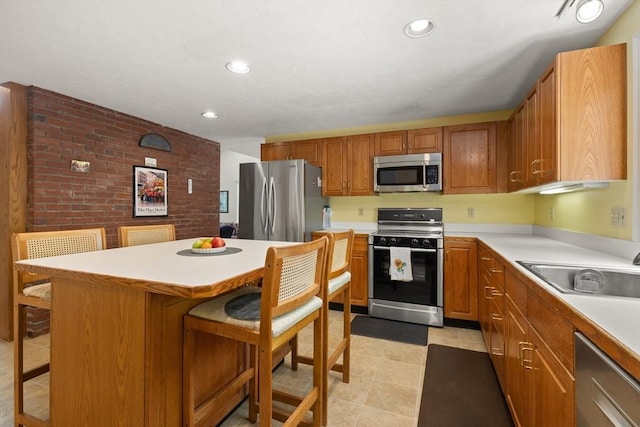 12 Robin Ln, Pepperell, MA 01463 - kitchen featuring appliances with stainless steel finishes, a sink, a kitchen breakfast bar, light countertops, and recessed lighting