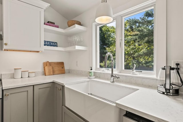 20 Judys Ln, Chatham, MA 02633 - kitchen with a sink, plenty of natural light, open shelves, and light stone counters