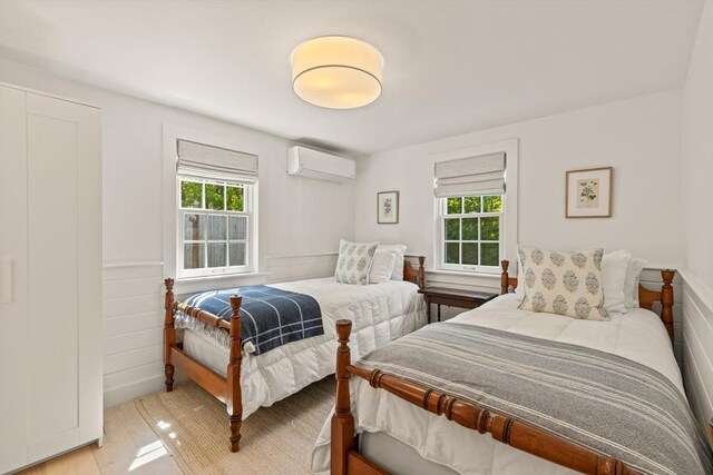 20 Judys Ln, Chatham, MA 02633 - bedroom featuring an AC wall unit and light wood-style floors