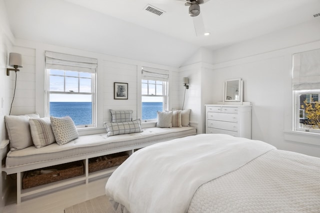 bedroom with lofted ceiling, wood-type flooring, ceiling fan, and a water view