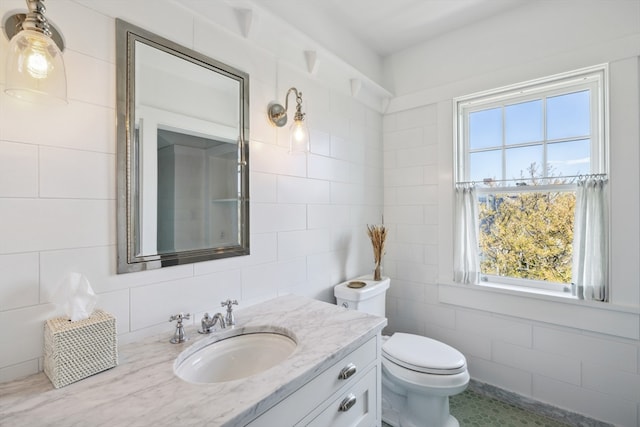 bathroom featuring tile walls, tile flooring, oversized vanity, and toilet