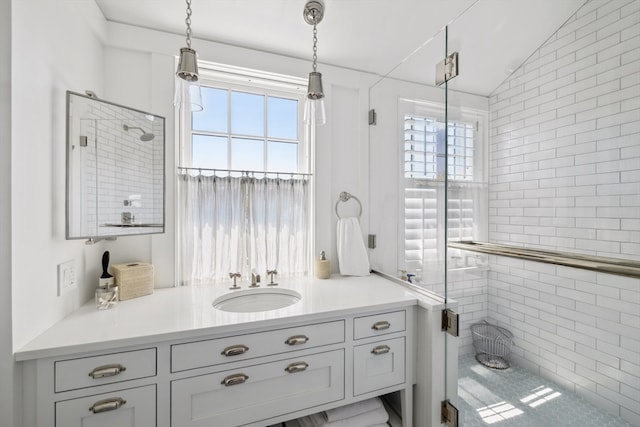 bathroom featuring a wealth of natural light, vanity, and lofted ceiling