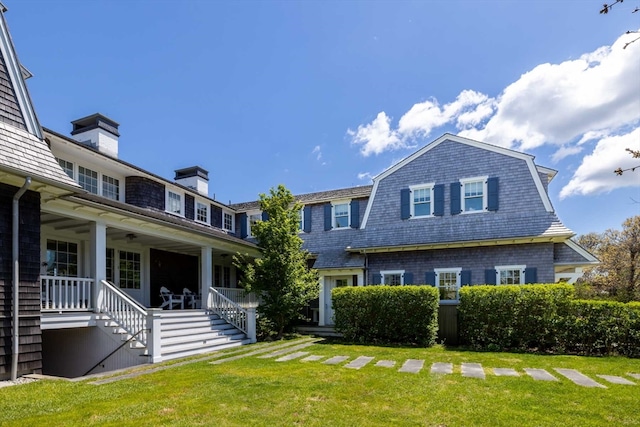 back of property featuring a yard and a porch