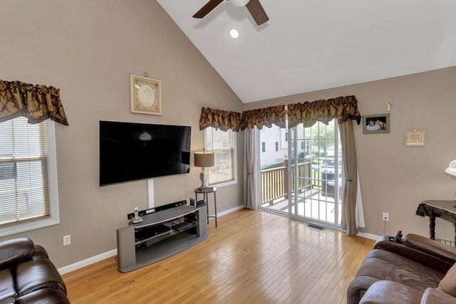 living area with ceiling fan, hardwood / wood-style floors, baseboards, high vaulted ceiling, and recessed lighting
