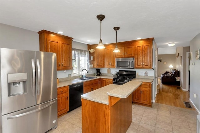 kitchen with black appliances, a sink, light countertops, brown cabinets, and recessed lighting