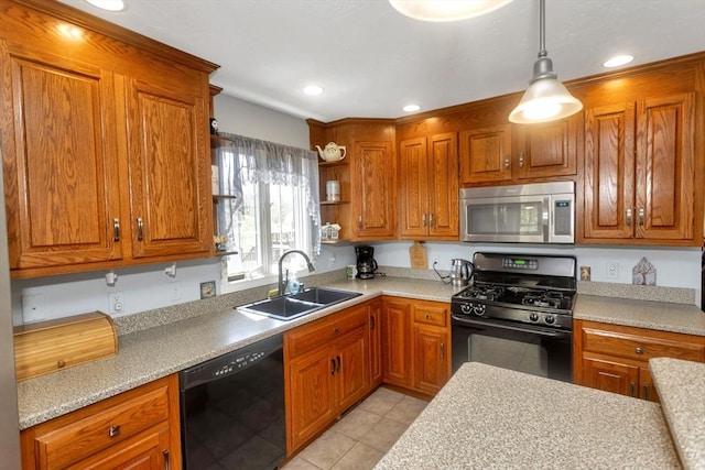 kitchen featuring black appliances, a sink, light countertops, brown cabinetry, and recessed lighting