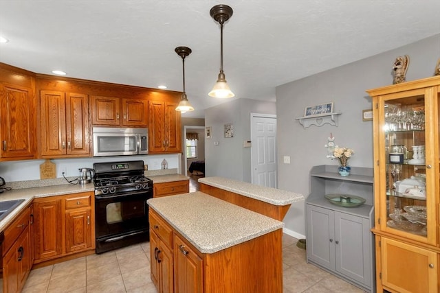kitchen with stainless steel microwave, black gas range, light tile patterned floors, a kitchen island, and recessed lighting