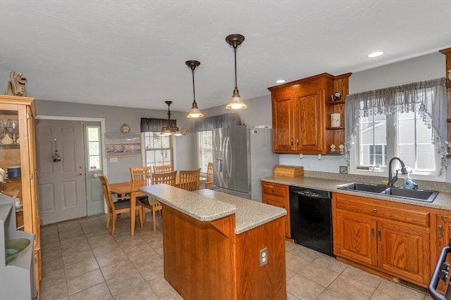 kitchen featuring a sink, black dishwasher, stainless steel fridge with ice dispenser, a kitchen island, and light tile patterned floors