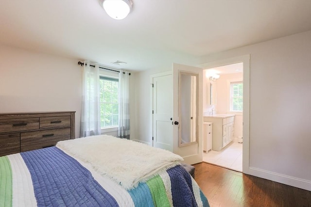 134 W Bacon St, Plainville, MA 02762 - bedroom featuring wood finished floors, baseboards, a sink, and connected bathroom