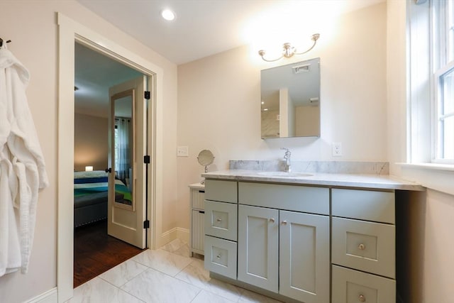 134 W Bacon St, Plainville, MA 02762 - ensuite bathroom with vanity, marble finish floors, and baseboards