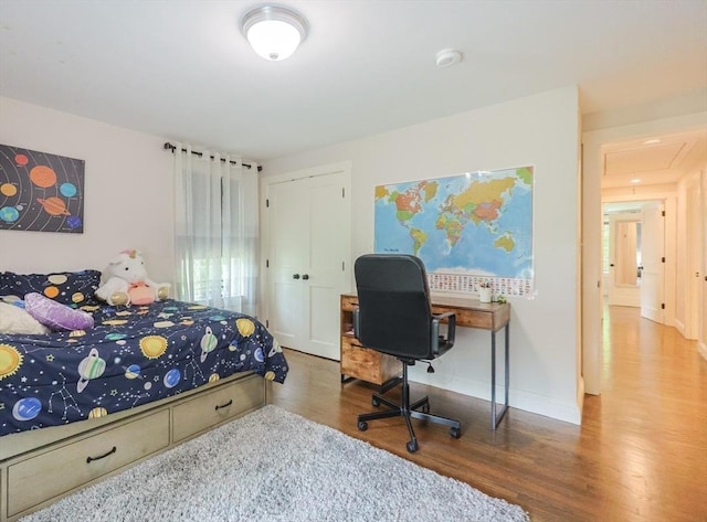 134 W Bacon St, Plainville, MA 02762 - bedroom with wood finished floors, attic access, a closet, baseboards, and an office area