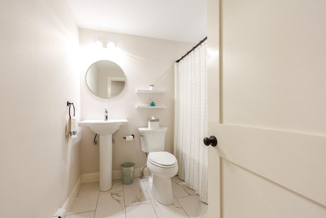 134 W Bacon St, Plainville, MA 02762 - bathroom featuring toilet and marble look tile flooring