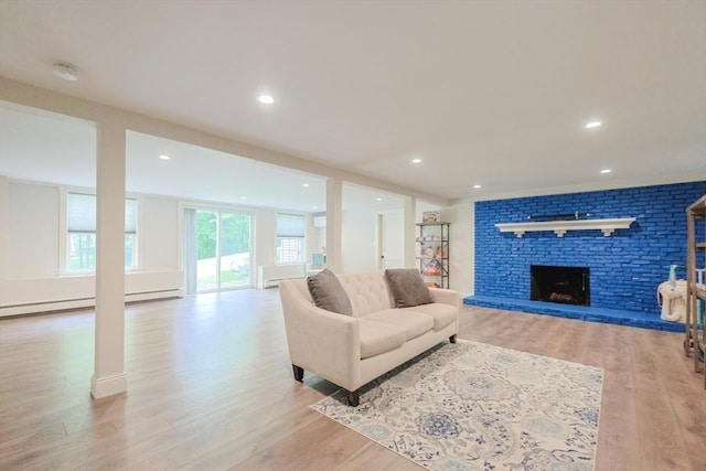 134 W Bacon St, Plainville, MA 02762 - living area featuring light wood finished floors, a fireplace, baseboard heating, a baseboard radiator, and recessed lighting