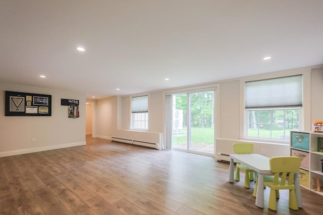 134 W Bacon St, Plainville, MA 02762 - living room featuring a baseboard heating unit, wood finished floors, recessed lighting, and baseboards