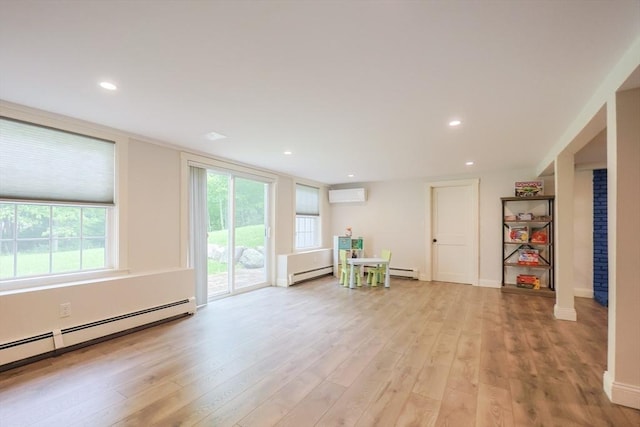 134 W Bacon St, Plainville, MA 02762 - living area featuring a wall unit AC, baseboard heating, light wood-style floors, recessed lighting, and a baseboard radiator