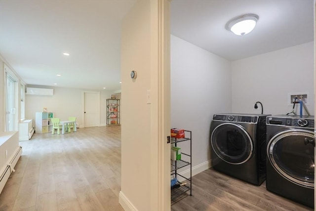 134 W Bacon St, Plainville, MA 02762 - laundry area featuring washing machine and clothes dryer, a wall unit AC, light wood-style flooring, a baseboard radiator, and recessed lighting
