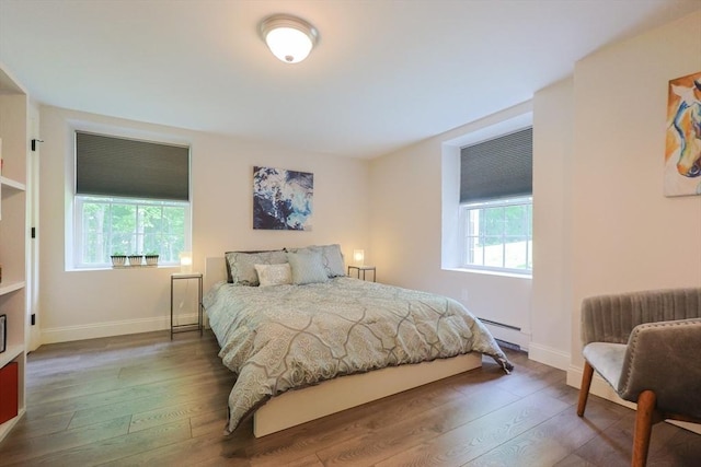 134 W Bacon St, Plainville, MA 02762 - bedroom featuring baseboard heating, wood-type flooring, and baseboards