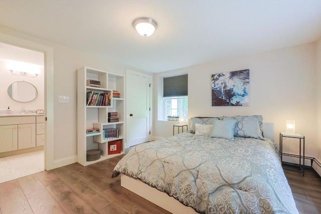 134 W Bacon St, Plainville, MA 02762 - bedroom featuring wood finished floors, a sink, baseboards, and connected bathroom