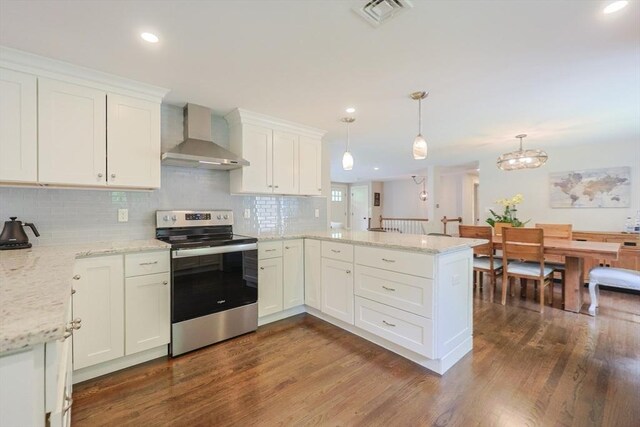 134 W Bacon St, Plainville, MA 02762 - kitchen with stainless steel electric range oven, wall chimney exhaust hood, a peninsula, dark wood-style flooring, and white cabinetry