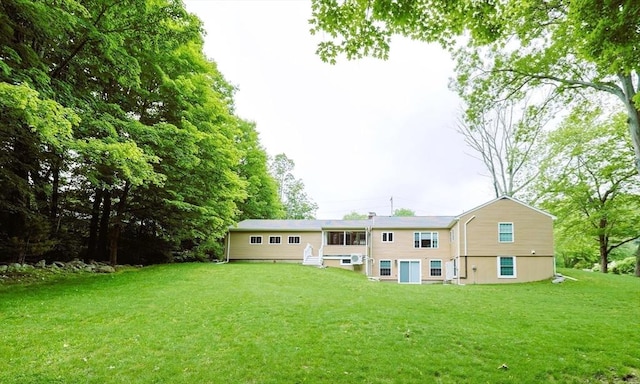 134 W Bacon St, Plainville, MA 02762 - rear view of house featuring a lawn