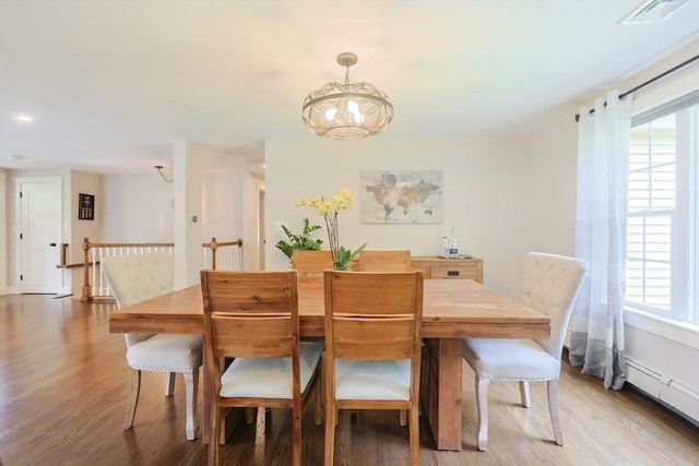 134 W Bacon St, Plainville, MA 02762 - dining area with wood finished floors, a chandelier, a baseboard radiator, and recessed lighting