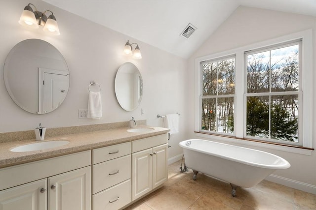 full bathroom with double vanity, visible vents, vaulted ceiling, and a sink