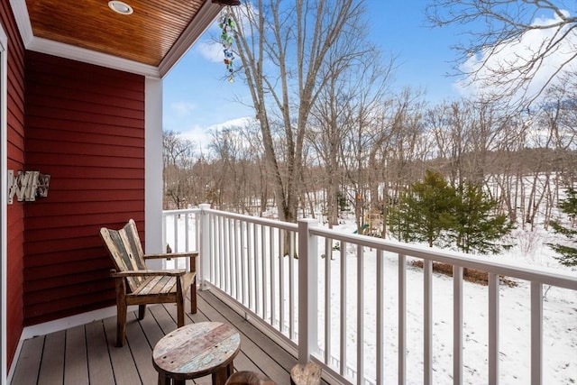 view of snow covered back of property