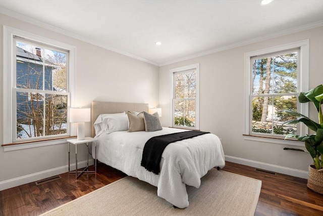 bedroom featuring multiple windows, visible vents, and baseboards