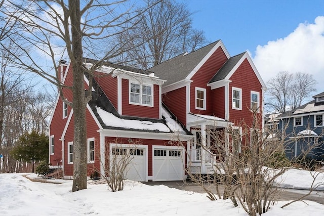 traditional-style house with a chimney and an attached garage