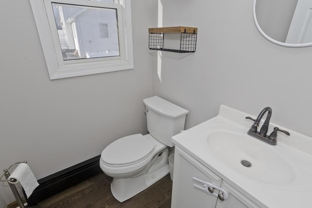 bathroom with vanity, wood-type flooring, and toilet