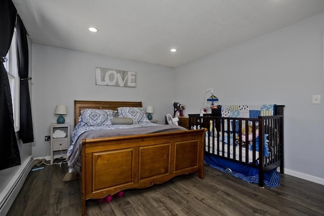 bedroom featuring dark wood-type flooring and baseboard heating