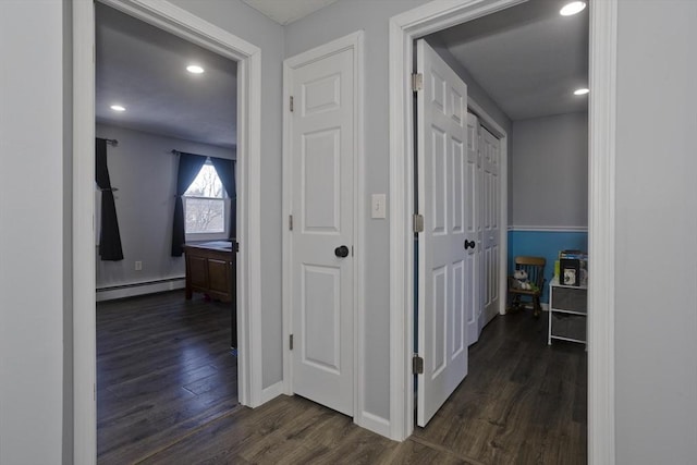 hallway with dark hardwood / wood-style flooring and a baseboard radiator