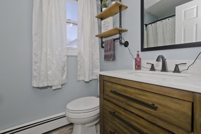 bathroom with vanity, baseboard heating, and toilet